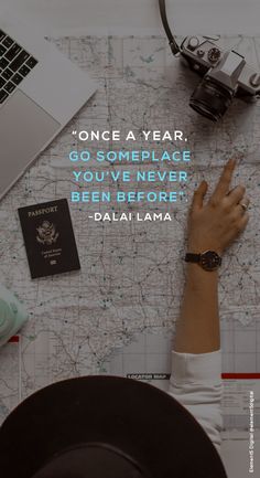 someone is sitting at a table with their hand on a map and the words, once a year go someplace you've never been before