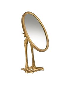 a golden bird shaped mirror sitting on top of a stand