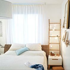 a bedroom with a white bed and window