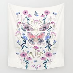 a white wall hanging with pink and blue flowers on it, featuring an image of a butterfly