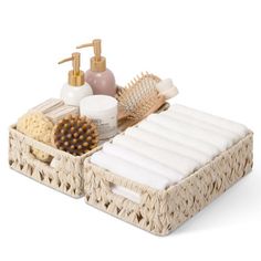 two wicker baskets with soaps, brush and lotion in them on a white background