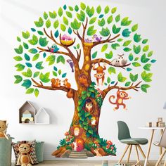 a children's room with an animal tree mural