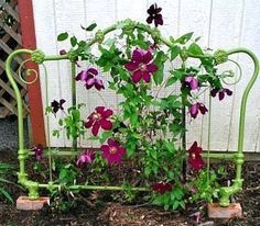 a bed frame with flowers growing out of it