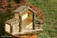 a bird house made out of wood and logs