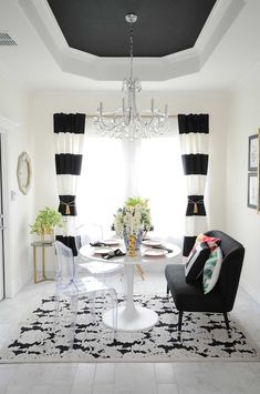 a black and white dining room with chandelier