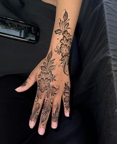 a woman's hand with tattoos on it