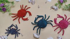 crocheted spiders and sea shells on a table