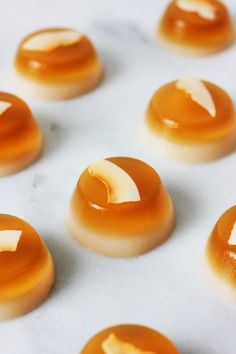 several pieces of food sitting on top of a white countertop covered in caramel