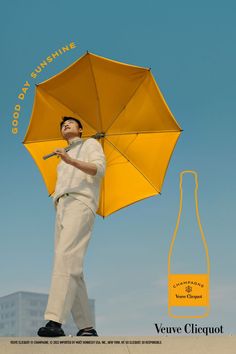 a man holding an umbrella in front of a bottle