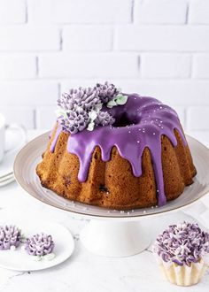 a bundt cake with purple icing and flowers on top