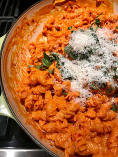 a pan filled with pasta and cheese on top of a stove