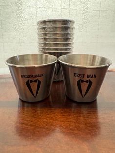 four metal bowls with the names groomman and best man on them sitting next to each other