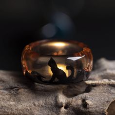 The ring is made of black hornbeam wood and brown jewelry resin with a bronze pot on a sliver. Bastet is the ancient Egyptian goddess of joy, fun and love, feminine beauty, fertility, hearth and cats, who was depicted as a cat or a woman with a cat's head. Recommendations for care The ring is made of wood with jewelry resin on the top, covered with special natural oils in order to preserve the wood from external influences, however, you should not soak the ring in water, scratch and hit the ring, because this can lead to deterioration of appearance or breakage Ring Cat, Ancient Egyptian Goddess, Egyptian Cat, Brown Jewelry, Glow Effect, Cat Ring, Wood And Resin, Egyptian Goddess, Jewelry Resin