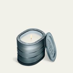 a candle that is sitting inside of a tin