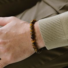 Return to the essentials. Essential for any contemporary man's jewelry assortment, these elastic stone bead bracelets are versatile enough to be worn individually or layered as preferred. - STONE: Tiger Eye (boosts confidence, aids harmony, enhances decision-making)- STONE SHAPE: Round- METAL COLOR: Brushed silver- METAL MATERIAL: 316L stainless steel- BRACELET TYPE: Elastic Stone Bead Bracelets, Gold Armband, Tiger Eye Bracelet, Tigers Eye Gemstone, Black Edition, Bracelet For Men, Confidence Boost, Bead Bracelets, Tiger's Eye