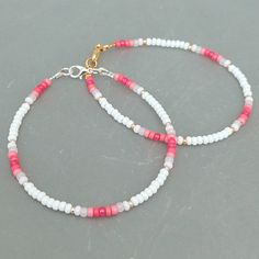 This pink summer seed bead bracelet has been lovingly made using good quality colourful 3mm glass Miyuki and Preciosa seed beads in pinks and white. Available with either 2mm silver or gold Miyuki seed beads to highlight. Threaded on strong stainless steel 7 strand Tiger Tail wire and finished with silver / gold plated wire guardians, a trigger clasp and optional extender chain. Matching necklace available on request. Matching Anklet available on request. More colours and designs can be found at: https://www.etsy.com/uk/shop/CraftHutCornwall BRACELET LENGTHS 6 1/2" Small 7"       Ladies - Small 7 1/2" Ladies - Standard (this is the most common size and generally the size most bracelets are made) 8"       Ladies - Standard Large / Mens - Standard 8 1/2" Ladies - Large / Mens - Standard Larg Cute Handmade Bracelets Beads, Design For Bracelet, Beaded Bracelets And Necklaces, Seed Bead Bracelets For Men, Small Beaded Bracelets Ideas, Bracelet Ideas With Small Beads, Matching Seed Bead Bracelets, Small Glass Bead Bracelet Ideas, 3mm Bead Bracelet