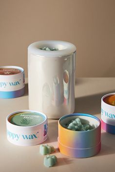 three different containers with candy in them sitting on a table