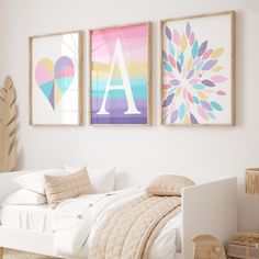 two paintings hang above a bed in a white bedroom