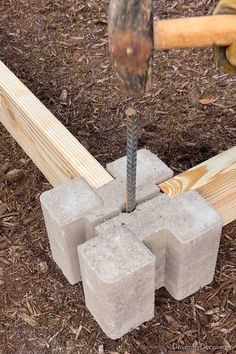 someone is using a hammer to cut concrete blocks