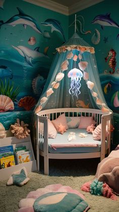 a child's room with an ocean theme and sea animals on the walls, including a bed