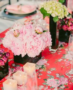 the table is set with flowers and candles