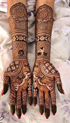 two hands with henna designs on them