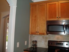 a kitchen with wooden cabinets and stainless steel appliances