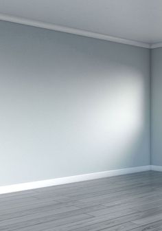 an empty room with white walls and wood floors