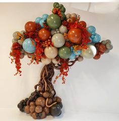 a balloon tree with lots of balloons attached to it's branches and foliage on top