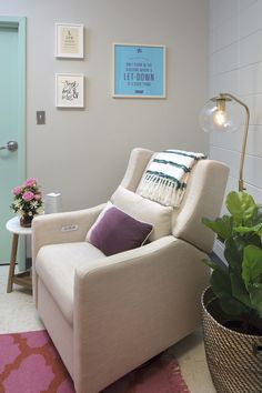 a white chair sitting next to a potted plant in front of a green door