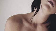 a close up of a woman with no shirt on