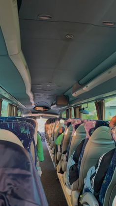 the interior of a bus with rows of seats