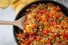 a skillet filled with mexican food and tortilla chips