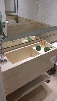 a bathroom sink sitting under a mirror next to a toilet and bathtub in a room