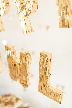 gold decorations hanging from the ceiling in a room