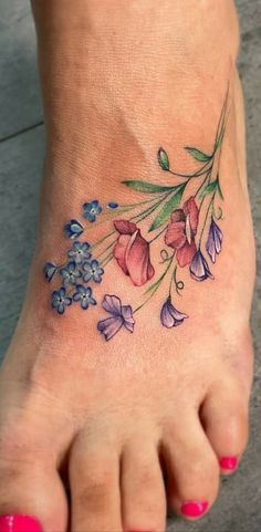 a woman's foot with flowers on it