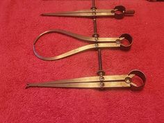 three pairs of scissors sitting on top of a red towel next to eachother