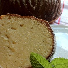 a loaf of bread with a green leaf on the side next to a bundt cake