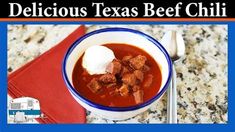 a bowl of beef chili with sour cream on top and the words delicious texas beef chili above it