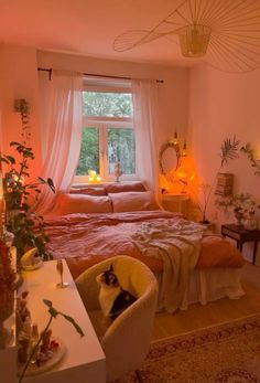 a bed room with a neatly made bed and a cat sitting on the chair next to it