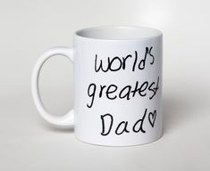 a white coffee mug with the words world's greatest dad written on it in black ink