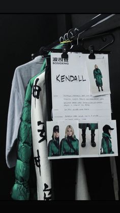 an advertisement for kendali is hanging on a coat hanger in front of a t - shirt