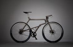 a silver bicycle with black spokes on a gray background