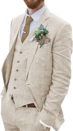 a man with a beard wearing a suit and flower brooch on his lapel