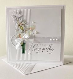 a white card with flowers on it and the words sympathy written in cursive writing