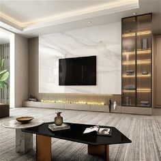 a living room with a large tv mounted on the wall above a black coffee table