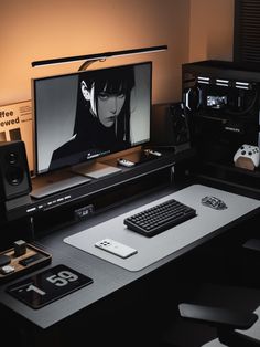 a computer desk with a monitor and keyboard on it, along with other electronic devices