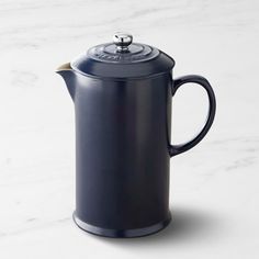 a black coffee pot with a lid and handle