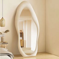 a large white curved mirror in a room