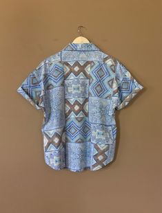 "Authentic vintage short sleeve button down shirt with 90's abstract design and oversized fit. Dates from early to late 90's. This shirt is in great clean condition with little signs of previous wear. Full button down front. Soft 100% cotton. Still has many years of wear left. Measurements (taken zipped/buttoned up and laid comfortably flat) x2 for circumference No Tag Size (Fits like Oversized Large) Shoulders 46\"/48\" Chest 44\" Bottom hem circumference 44\" Sleeve 6\" Top arm circumference 1 Patterned Relaxed Fit Shirt With Camp Collar, Vintage Print Relaxed Fit Summer Shirt, Casual Shirt With Vintage Print And Relaxed Fit, Casual Relaxed Fit Shirt With Vintage Print, Bohemian Button-up Top With Graphic Print, Summer Vintage Print Relaxed Fit Shirt, Relaxed Fit Vintage Print Summer Shirt, Bohemian Shirt With Relaxed Fit And Button Closure, Bohemian Relaxed Fit Shirt With Button Closure